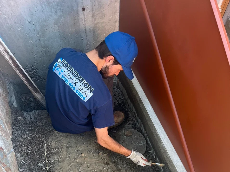 Foundation Crack Seal professional working on a bulkhead installation
