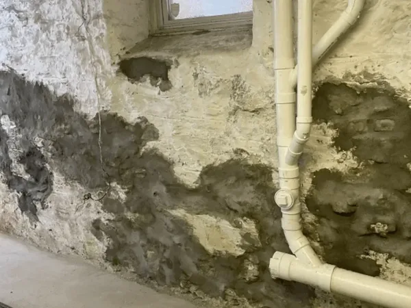 Deteriorating stone foundation wall requiring repointing