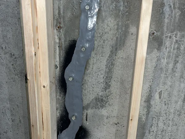 Foundation wall crack repair completed with injection ports along the sealed crack