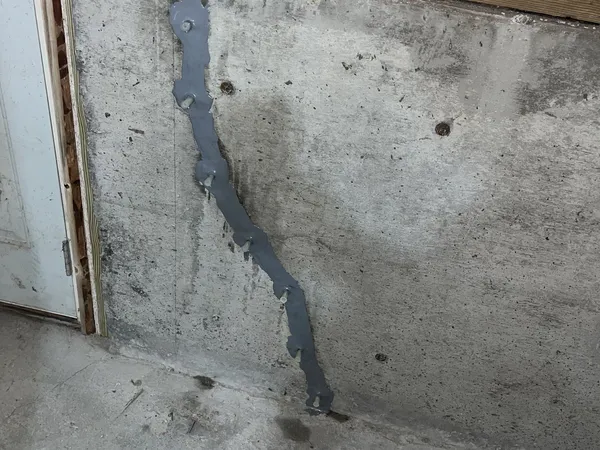 Completed foundation wall crack repair with injection ports and surface sealant