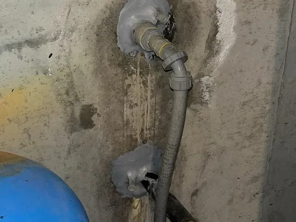 Leaking pipe penetrations sealed through concrete wall