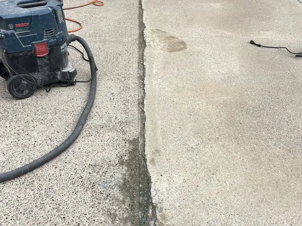 Worn concrete patio joint before resealing