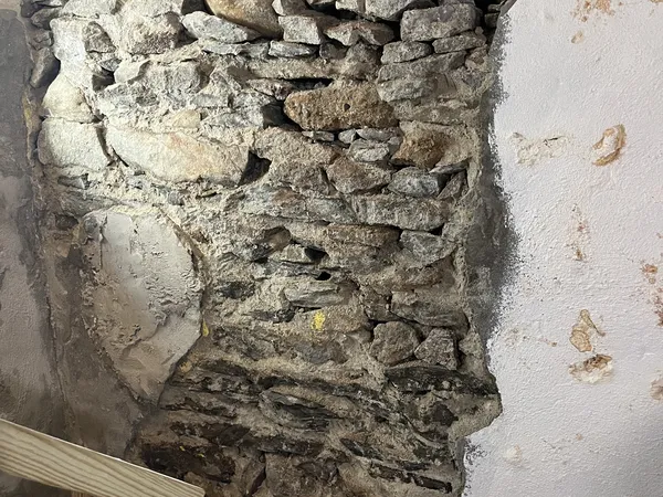 Interior stone foundation with deteriorated mortar before repointing