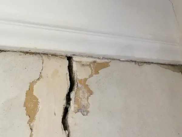 Interior wall crack with water damage requiring repair