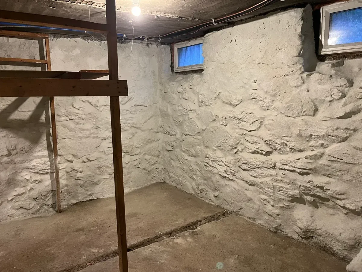 Stone foundation after repointing and painting by Foundation Crack Seal